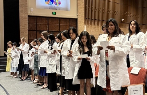Medical Laboratory Sciences students recite oath during white coat ceremony.