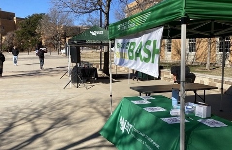 Canopy tents and tables set up along the library mall