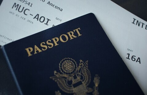 A passport cover and an airplane boarding pass