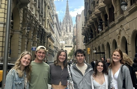 A group of students standing in front of a church in Barcelona, Spain