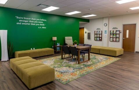 The counseling and testing services waiting room, with soft furniture and a green wall.