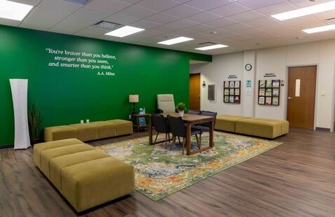 The counseling and testing services waiting room, with soft furniture and a green wall.