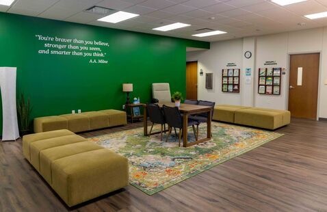The counseling and testing services waiting room, with soft furniture and a green wall.