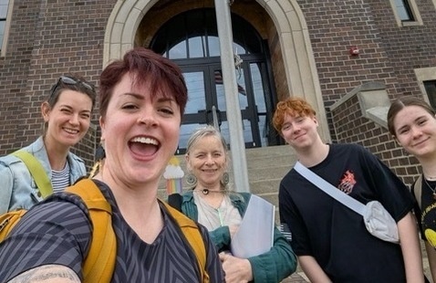Staff and students smile outside one of the retreat sites