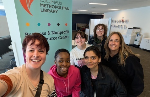 Staff and students smile outside one of the retreat sites
