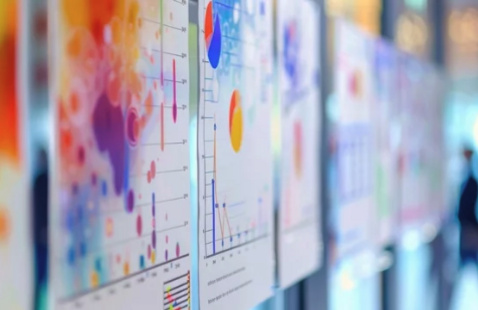 A person walks by a display at a poster session