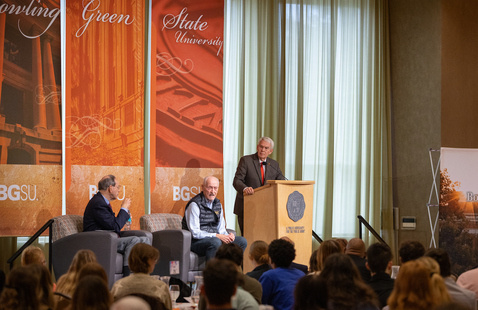 a group of speakers at a luncheon