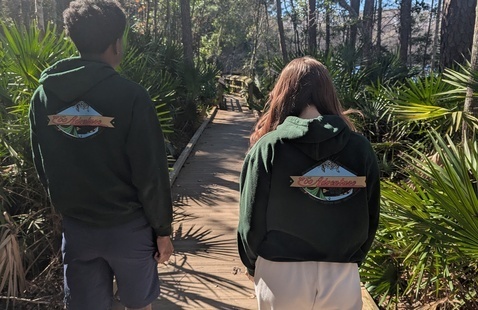 Two people walking on nature trail