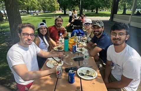 students eating at a picnic table.
