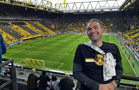 Bryan C. Clift, an assistant professor in the Department of Parks, Recreation and Tourism, in the stands at a soccer game.