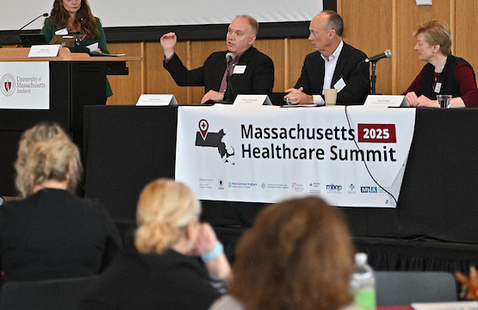 Three panelists and a moderator speak at a previous summit.