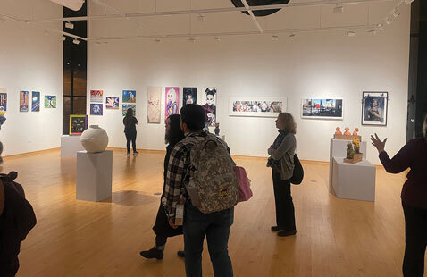Appears to be individuals atending the art show at Oakton College.