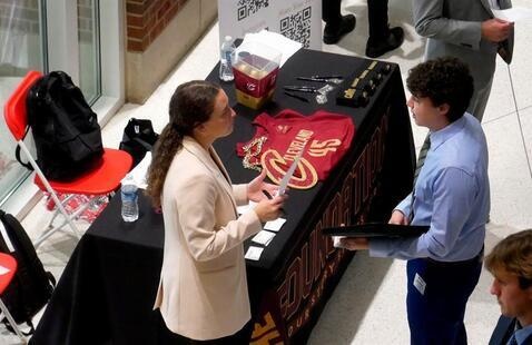 Employer and student speaking at a career fair