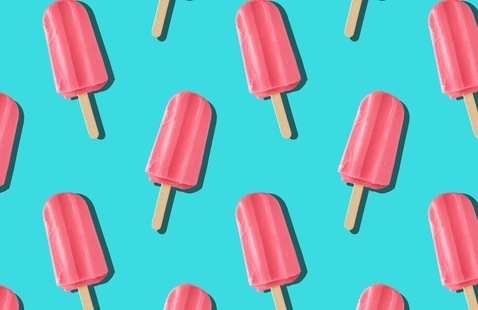 Pink popsicles with a blue background