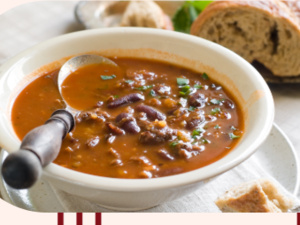 A photo of homemade black bean soup and bread