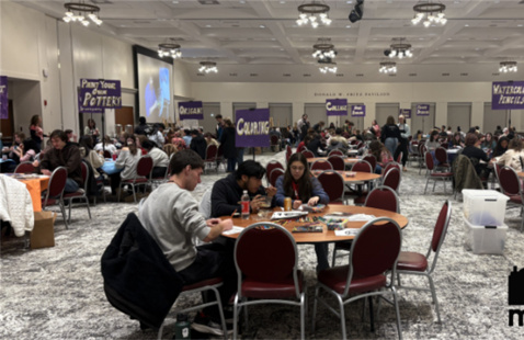 Armstrong Pavilion full of round tables packed with students working on arts and crafts projects. 