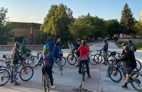 Group of bikers with helmets in front of the SUU Library
