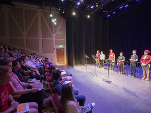 A crowd watches students on stage at Banned Books Onstage event.
