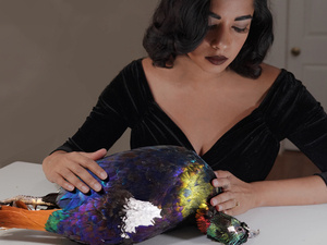 artist holding bird for taxidermy