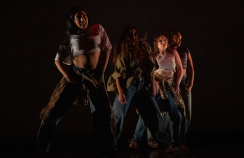 4 women dancing in a diagonal formation, wearing jeans and crop tops