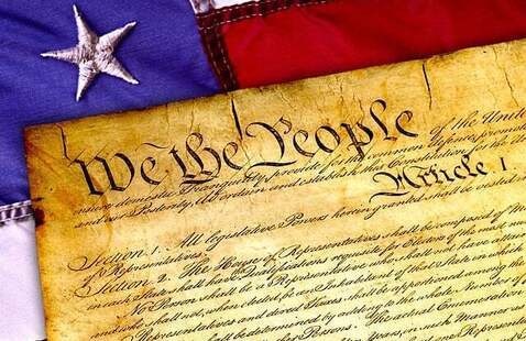 The Declaration of Independence with a flag in the background.