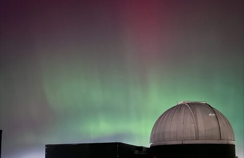 northern lights in green and pink visible over the BSU observatory
