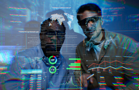 Two people looking at a holographic dashboard with numbers and charts.