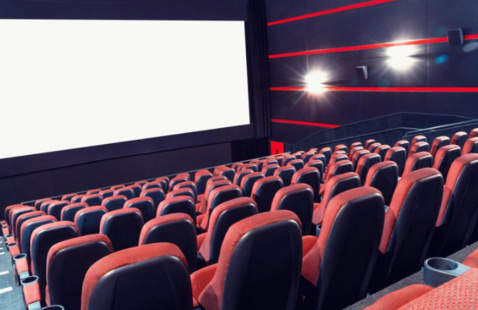 An empty theater with a blank screen.