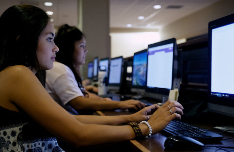 students viewing content on computer monitors