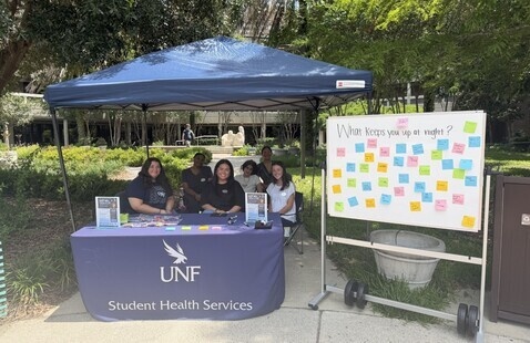 Interns with Student Health Services tabling and providing peer education