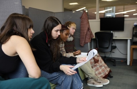Students look at a packet and work together in the Howe CMD lab.