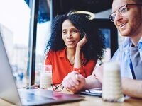 Two individuals taking part in webinar