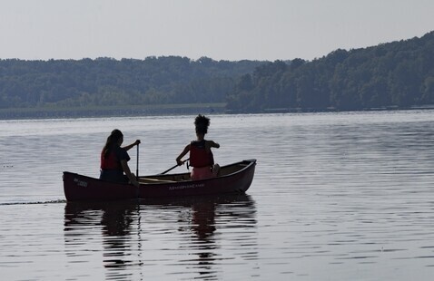 2 people canoeing on lake