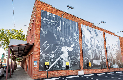 Side view of Voices of Pensacola showcasing historic photography mural.
