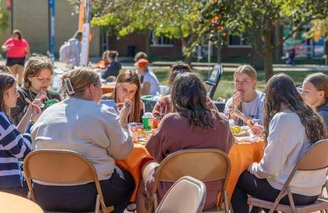Students eating together at Falcon Fest.