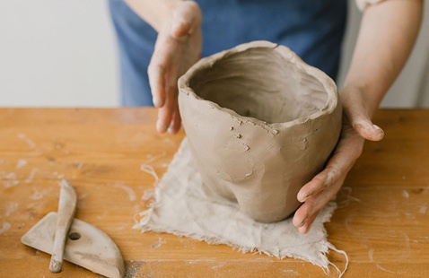 Person making clay bowl