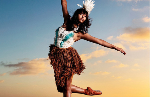 Woman dancing with blue sky and white clouds in the background