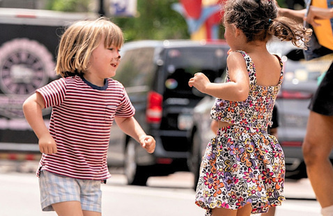 Two kids playing outside at an event