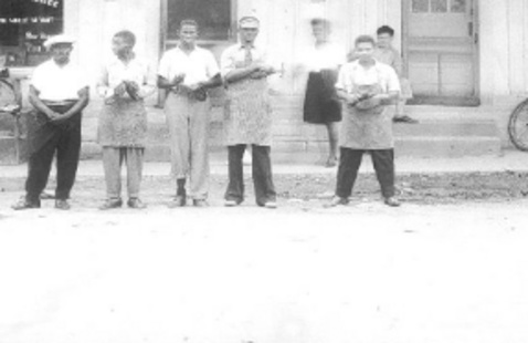 Frank Moris (in visor) in front of his shoe shop, Ferriday, La. Photo courtesy of Concordia Sentinel. 