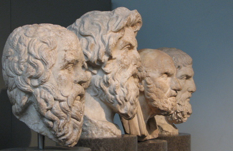 Four stone busts of Greek philosophers.