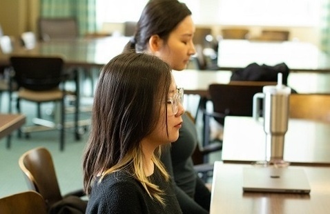 Students meditating at a desk