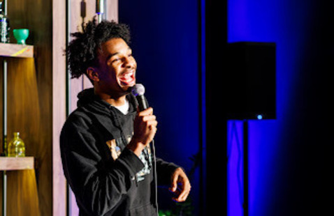 Elijah Nevels holding a microphone
