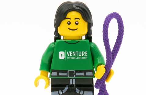 Lego figurine holding a climbing rope