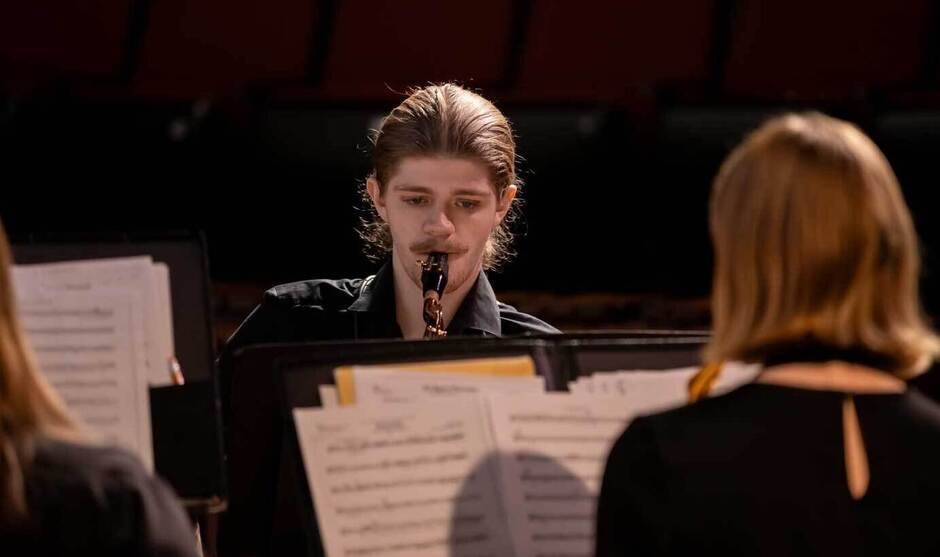 Person playing saxophone in concert