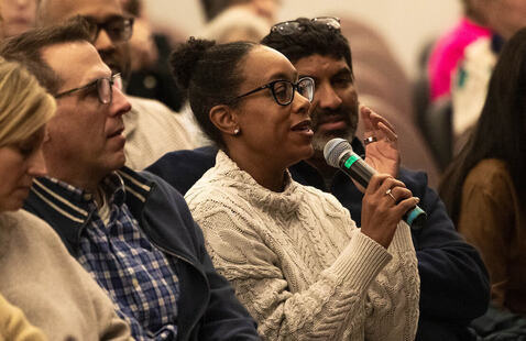 Audience member speaks into microphone during event