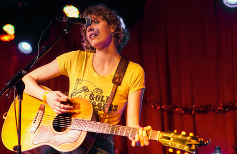 A woman performing at an open mic event.