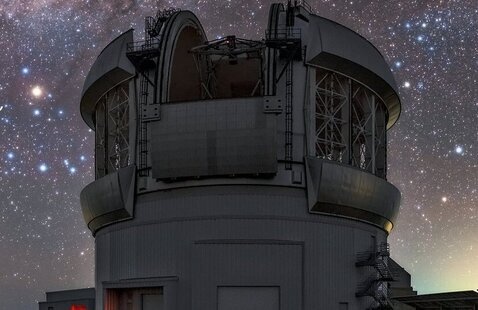 An observatory surrounded by a starry night sky.