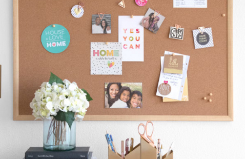 A corkboard with various photos and messages.