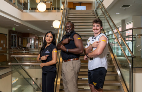 Three people showing they received the flu shot