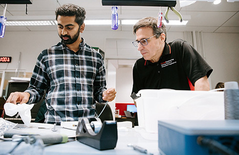 Biomedical engineering student and professor in a lab